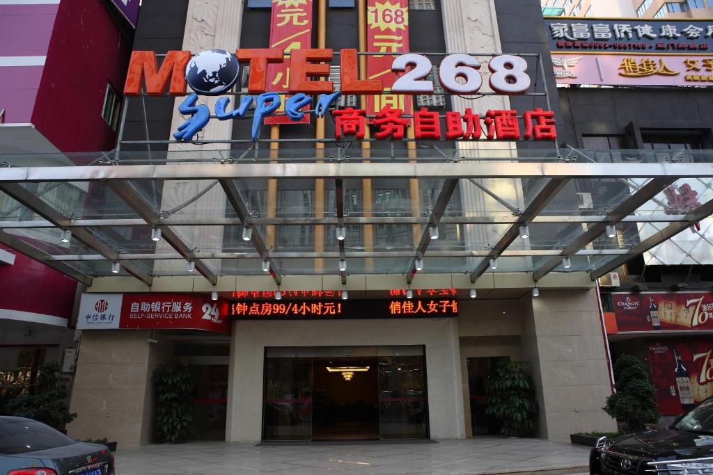 a building with a sign on top of it at Motel Xiamen Railway Station in Xiamen