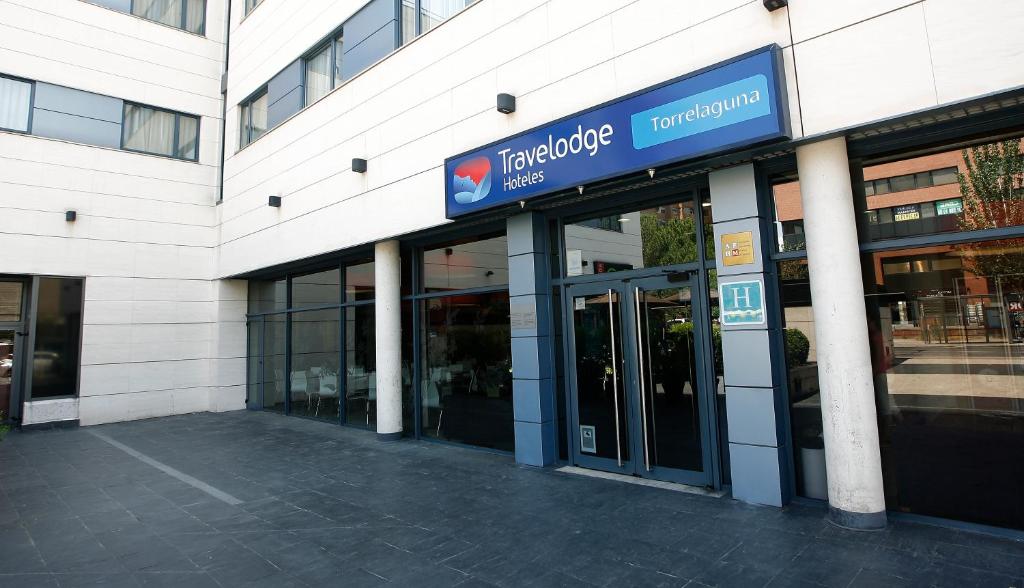 a building with a sign on the side of it at Travelodge Madrid Arturo Soria in Madrid