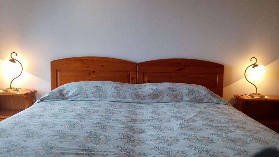 a bedroom with a bed with two lamps on two tables at Agriturismo Zì Carmine in Agerola