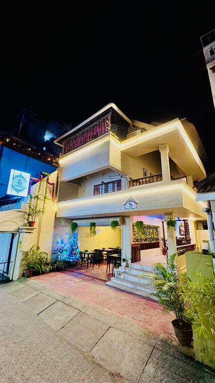 a large white building with a table in front of it at Scarlets Inn in Cochin