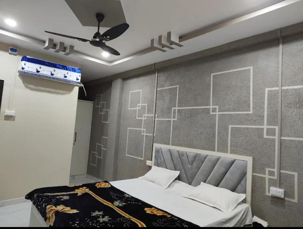 a bedroom with a bed and a wall with drawings on it at Malti palace in Sāgar