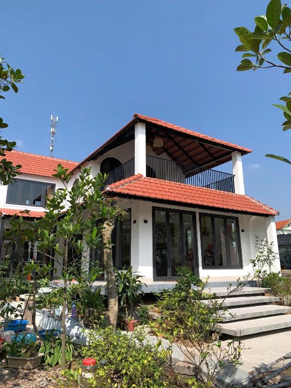 a white house with a red roof at The Little Home in Xuân Dục