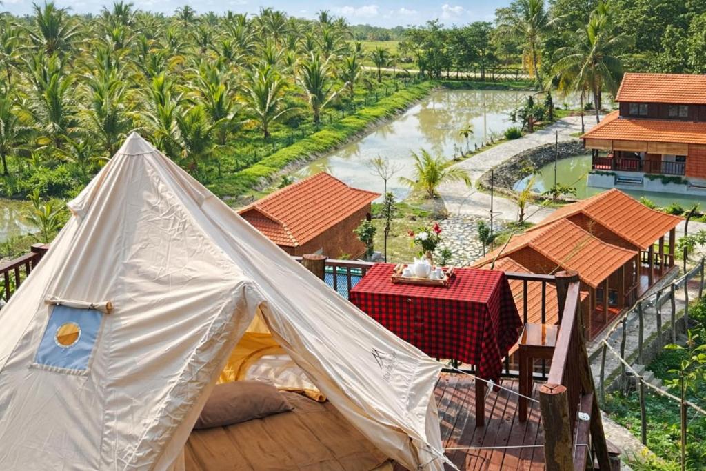 a tent on a balcony with a view of a river at Dream Hill Homestay in Cat Tien