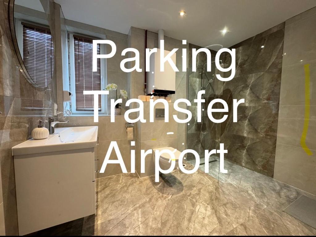 a bathroom with a sink and a shower with the words parking transfer airport at Air AMBER PEN LOTNISKO parking in Kaszów