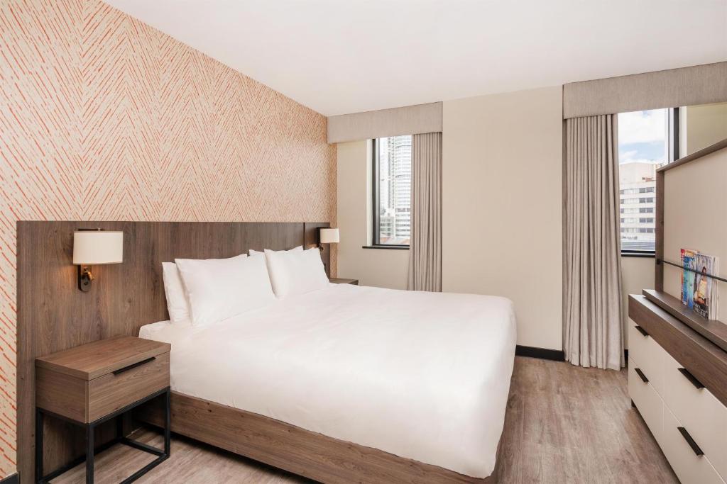 a bedroom with a large white bed and a window at Hyatt House Aparthotel Leeds in Leeds