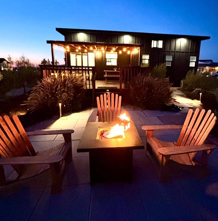 a patio with two chairs and a table with a fire at The Ultimate View - Private Spa & Fireplace in Temecula
