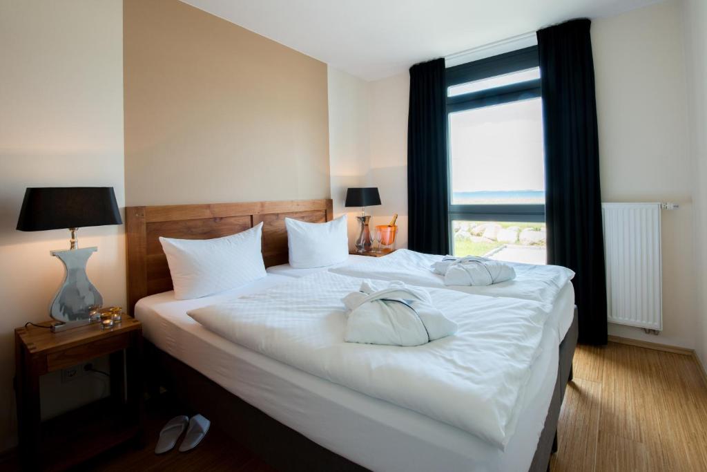 Postel nebo postele na pokoji v ubytování Aparthotel Ostseeperle Glowe - schön gestrandet