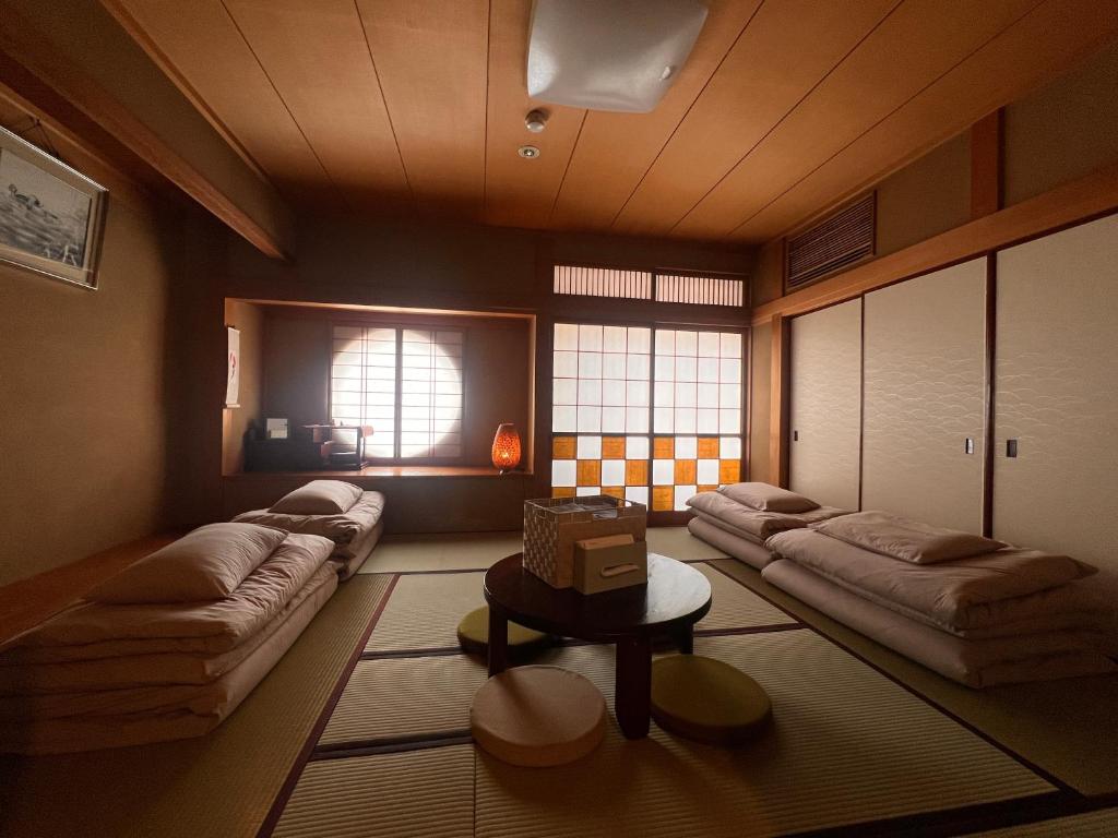 a living room with couches and a table at Guest House WA in Kyoto