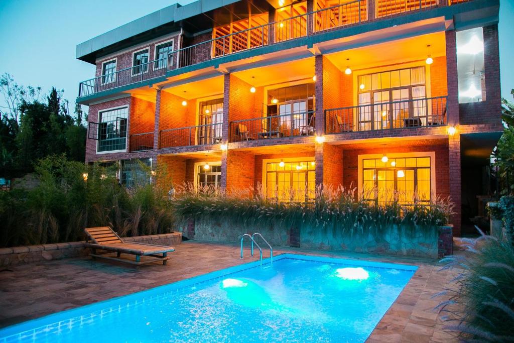a house with a swimming pool in front of it at Zondela House in Nkoanrua