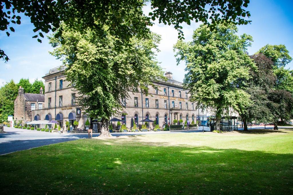 a large building with trees in front of it at White Hart Hotel & Apartments in Harrogate