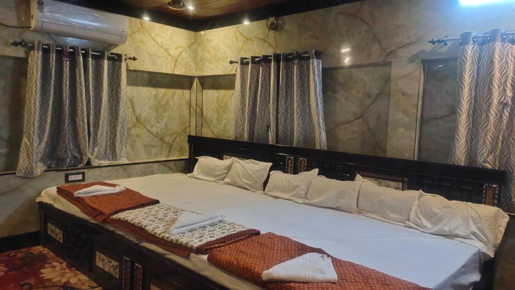 a bedroom with a large bed with a mirror at DD Gardens in Rāmeswaram