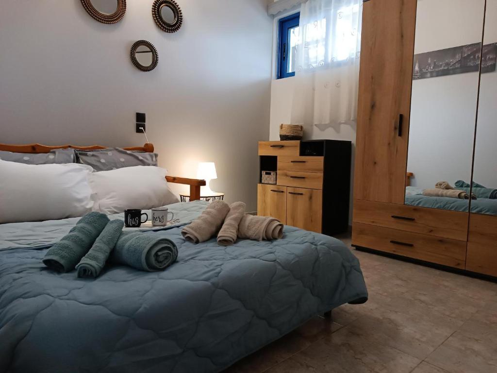 a bedroom with a bed with pillows on it at Thea Home Rhodes Pastida in Pastida