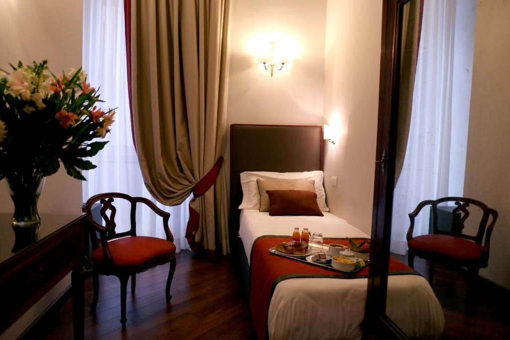 Postel nebo postele na pokoji v ubytování Decumani Hotel De Charme