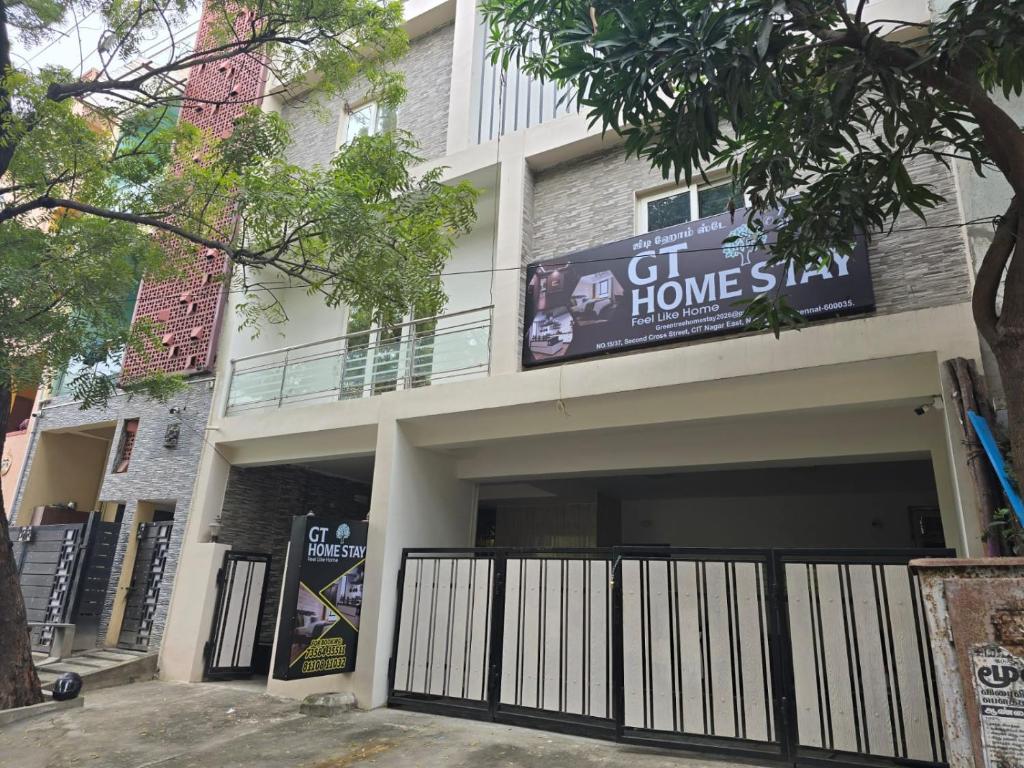 a building with a sign that reads gut home stay at GT Homestay in Chennai