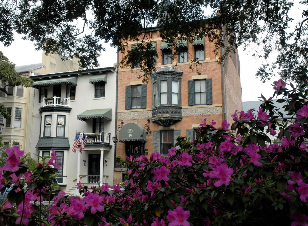 a building with pink flowers in front of it at Foley House Inn in Savannah