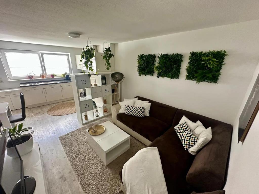 a living room with a couch and plants on the wall at Ruhige Ferienwohnung in Appenweier