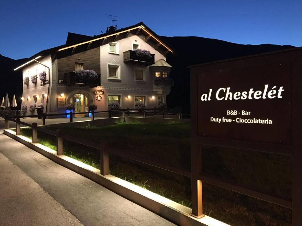 a sign in front of a building at night at Al Chestelet in Livigno