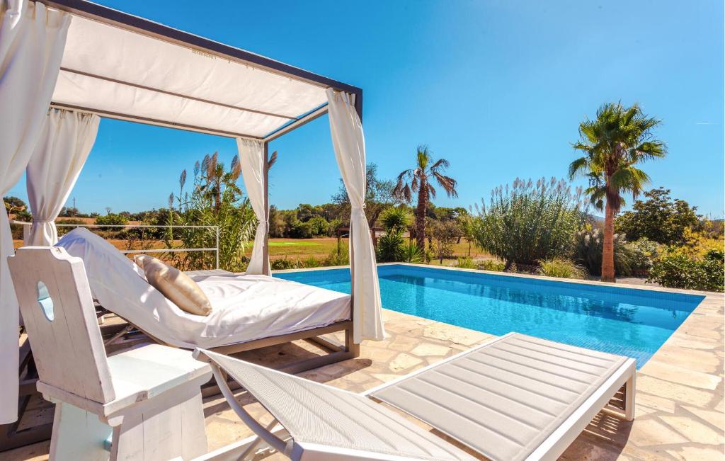 a patio with a swing and a swimming pool at Holiday Home Finca Ses Tanques in Algaida