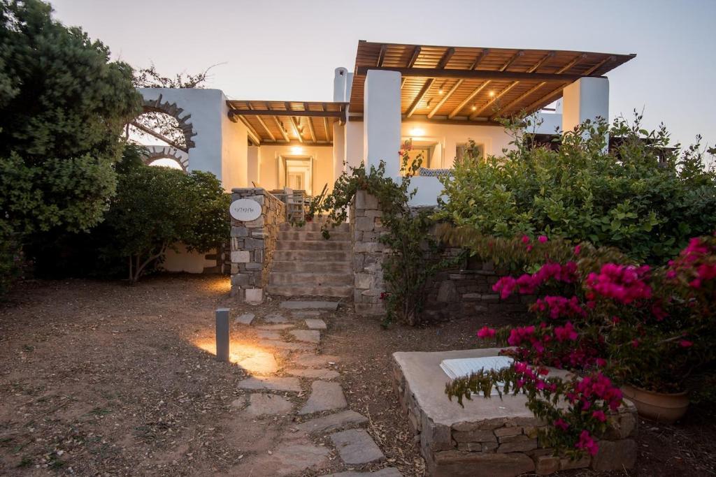 a house with a stone staircase in front of it at Seaview Villa Euterpe in Ambelas