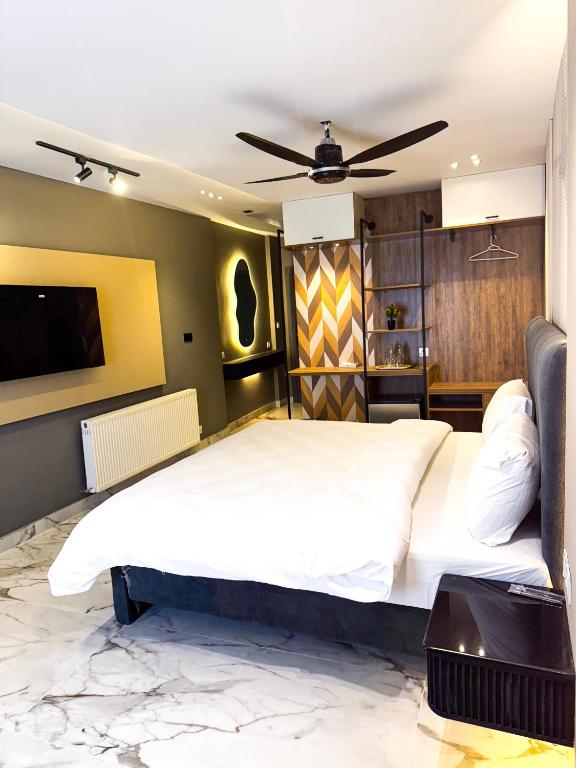 a bedroom with two beds and a flat screen tv at Metropole Hotel in Murree
