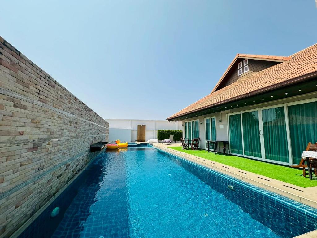 a swimming pool in front of a building at The Villa Jomtien Pattaya By Ahmed in Jomtien Beach