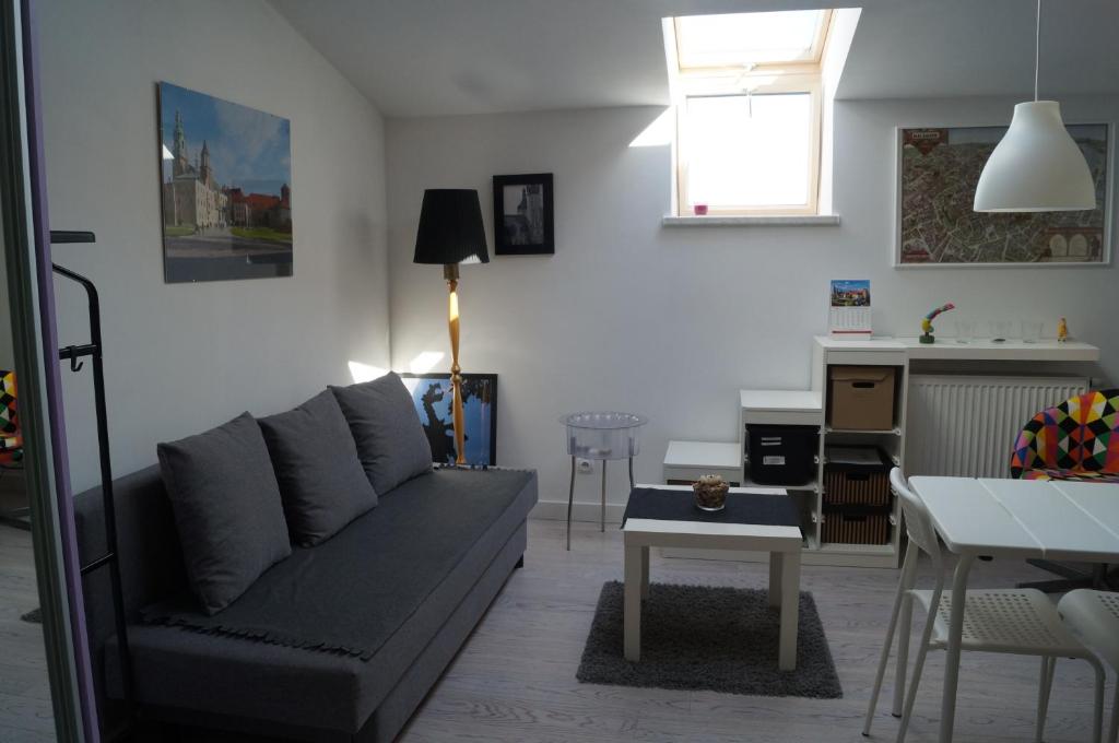 a living room with a couch and a table at Apartament Ariańska in Kraków