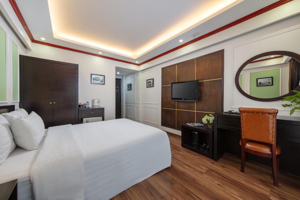 a hotel room with a bed and a television at Viet Hotel in Hanoi