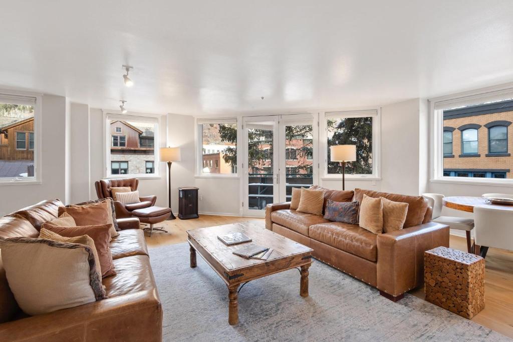 a living room with two couches and a table at Ice House 317 condo in Telluride