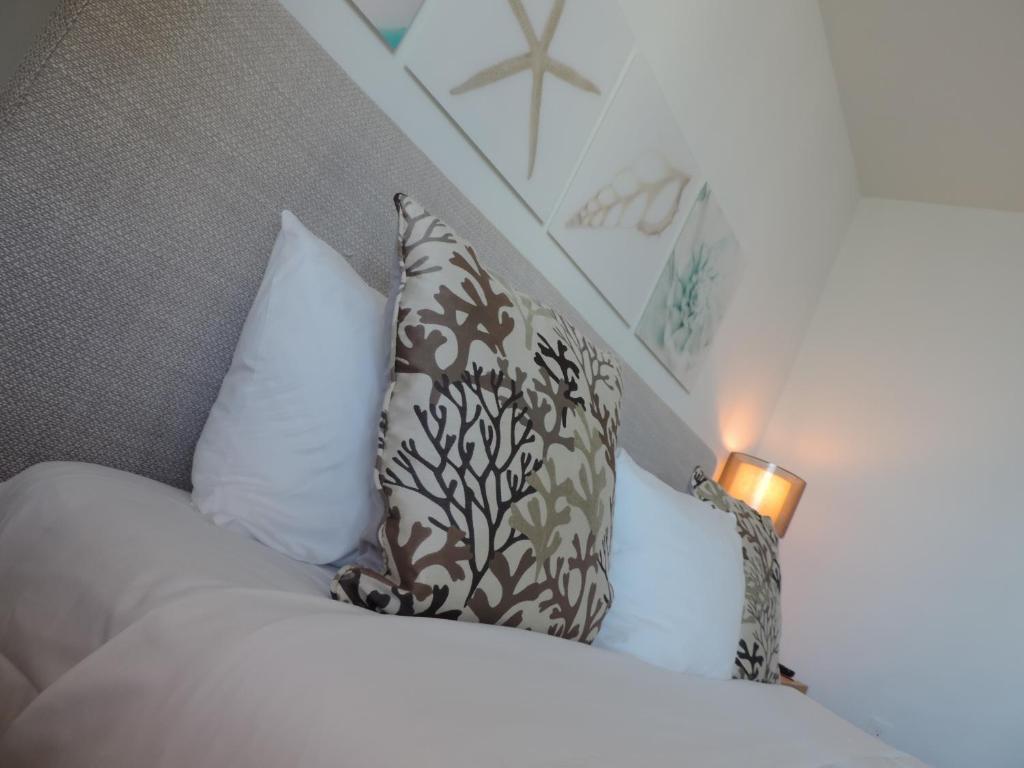 a bedroom with a bed with two pillows at Beach Walk Resort Lux Apartment in Hollywood