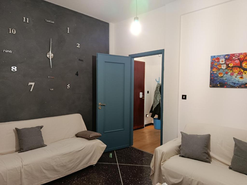 a living room with a couch and a blue door at Via Roma 48 in Arquata Scrivia