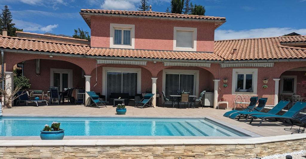 a house with a swimming pool in front of a house at Shanaël in Gap