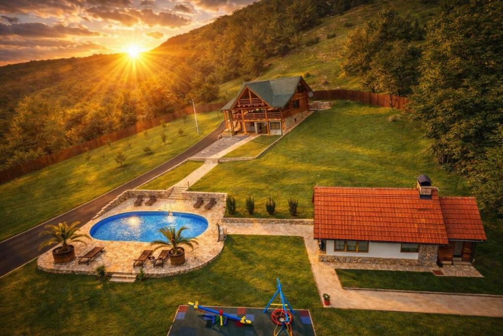 an aerial view of a house with a swimming pool at Luxury Family Lodge - Pool, Spa & Tennis Paradise in Gospić