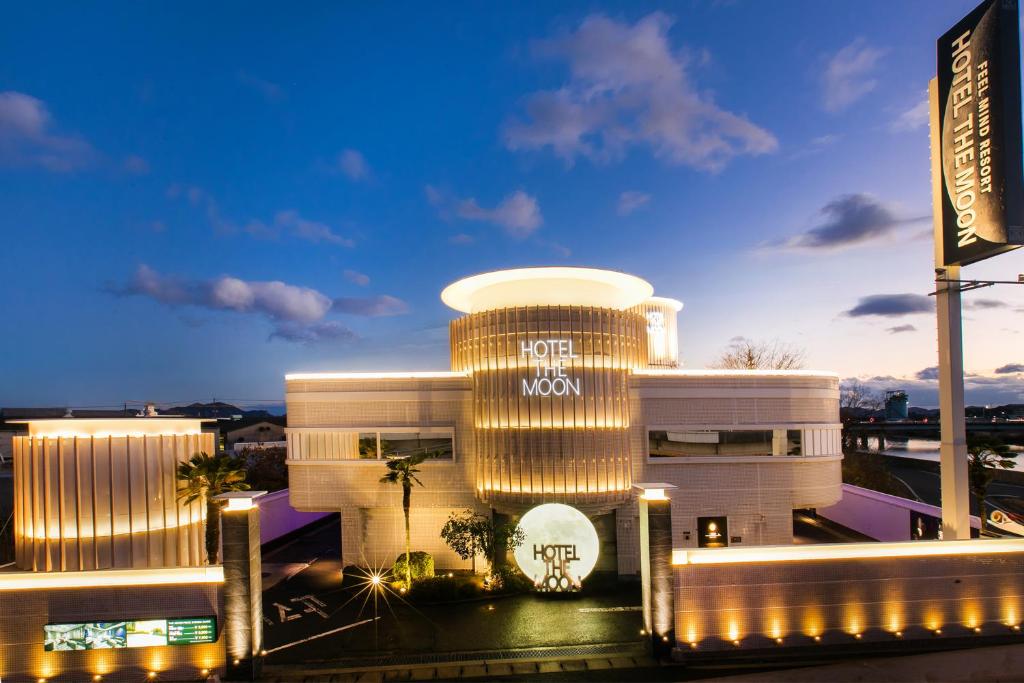 a large white building with a sign on it at Hotel The Moon -Adult Only- in Okayama