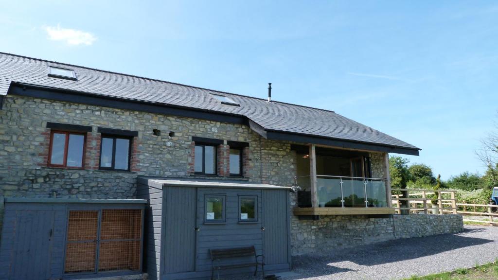 a detached stone house with a garage at Y Golomen in Cardiff