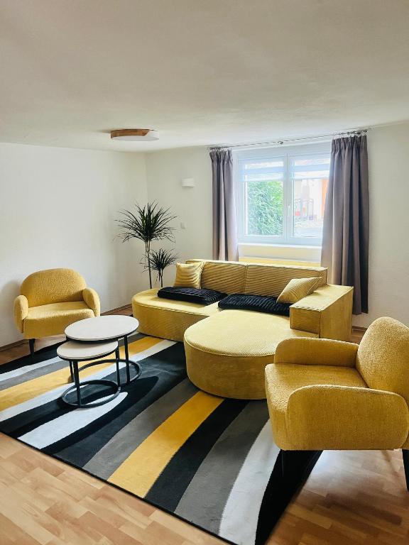 a living room with a couch and two chairs at Ferienhäuser Radebeul "Apartment Altkötzschenbroda" in Radebeul