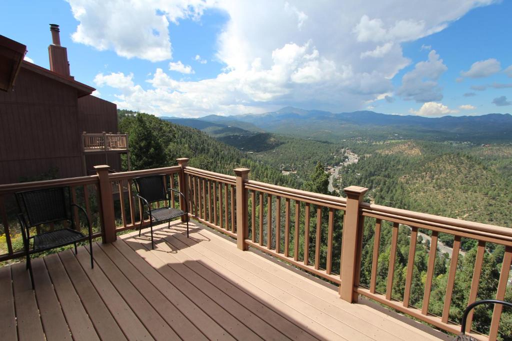 a balcony with chairs and a view of the mountains at Crown Point Resort, by VRI Americas in Ruidoso