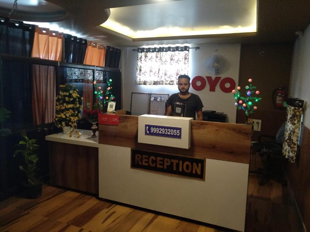 a man standing at a reception counter in a store at Jugnu hotel in Rohtak