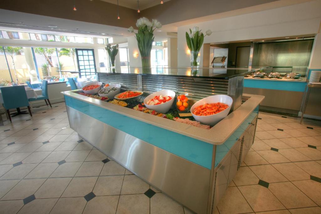 a buffet in a restaurant with bowls of food at Mantra Legends Hotel in Gold Coast