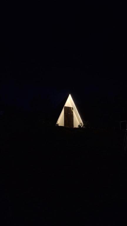 a small white building with a door in the dark at Secret valley vattavada in Vattavada