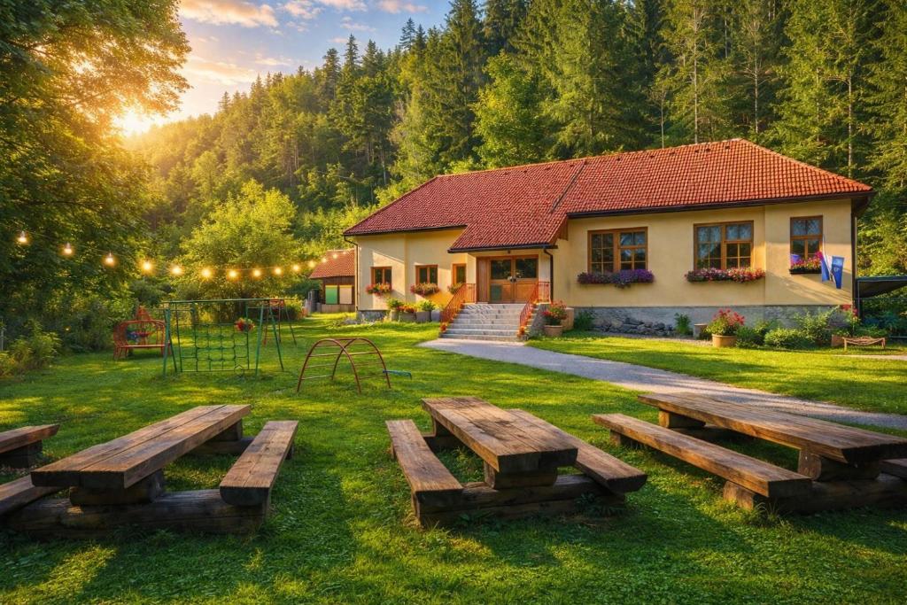 a house with a picnic table in the yard at Črjanski Raj in Črna na Koroškem