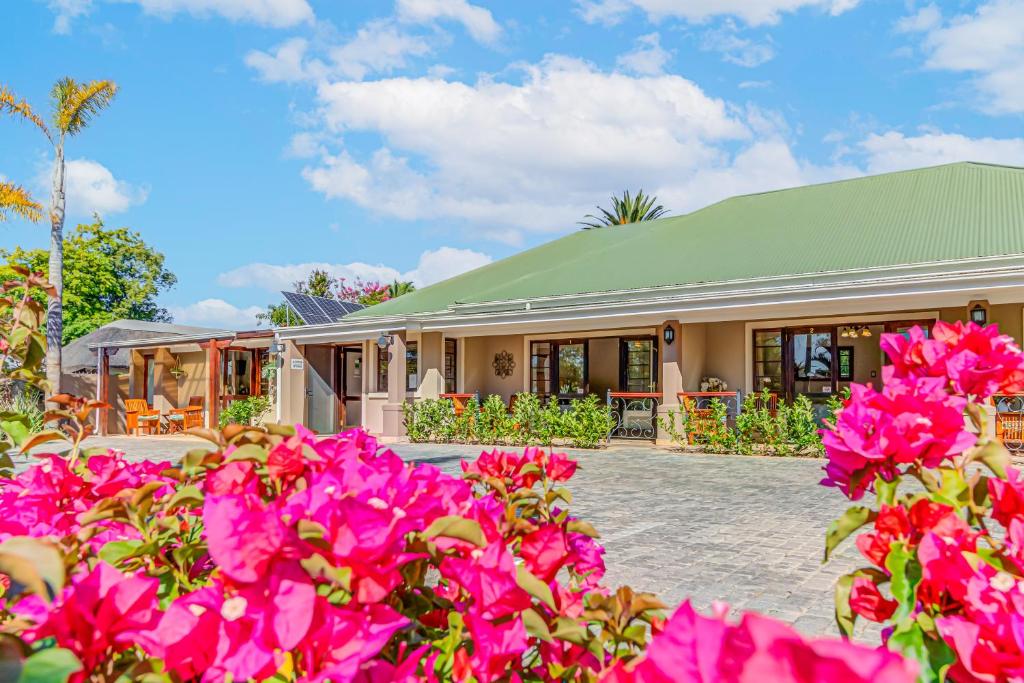 a house with pink flowers in front of it at Caledon 23 Guest House in George