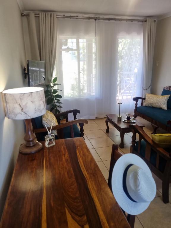 a living room with a table and a couch at Bultpark Apartment in Potchefstroom