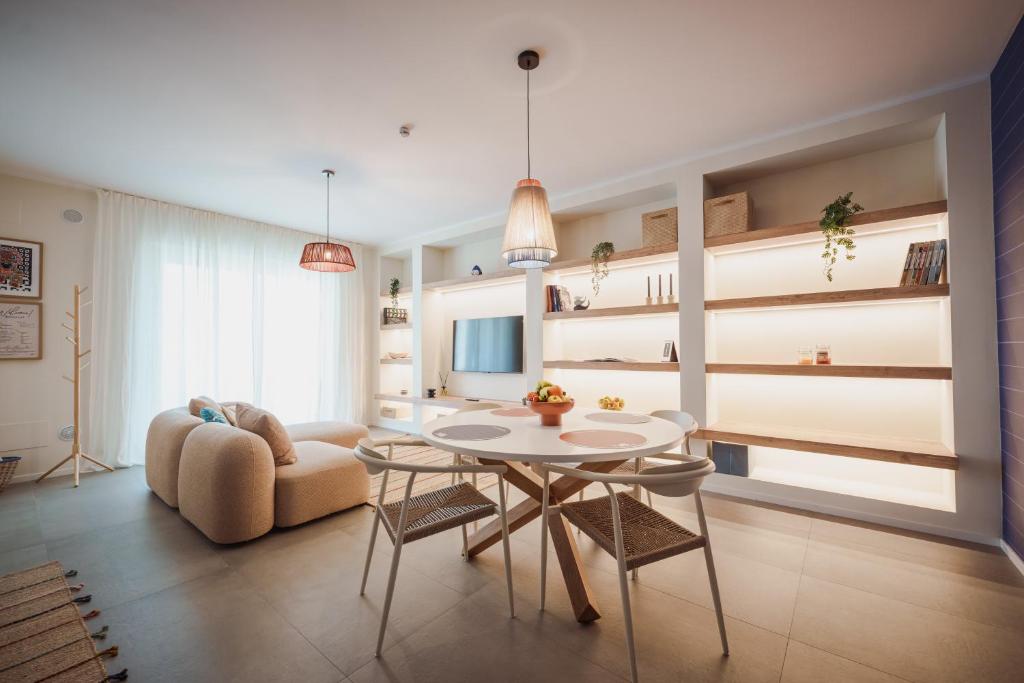 a living room with a table and a couch at Casa Costa Sud in Bari