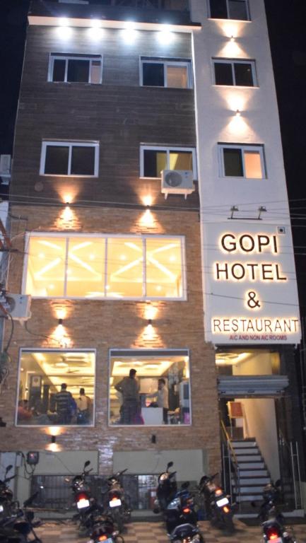 a building with motorcycles parked in front of a hotel at Gopi Hotel And Restaurant in Sāgwāra