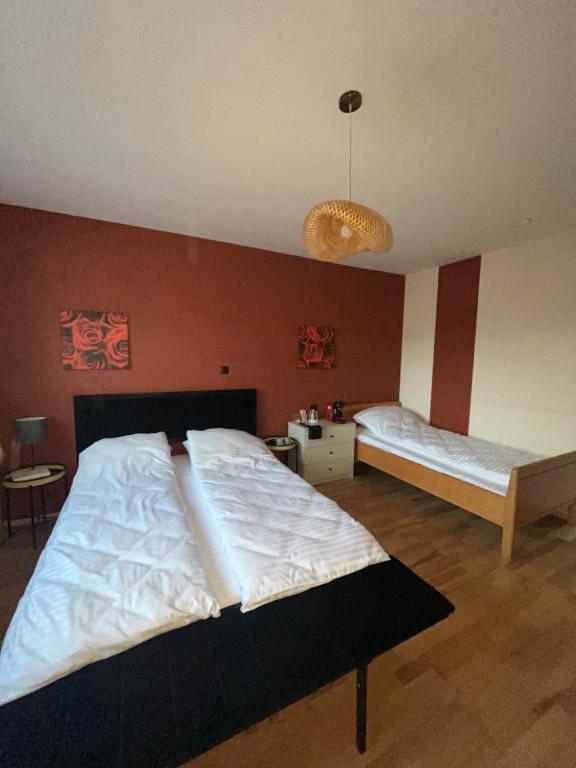 a bedroom with two beds and a chandelier at Ferienwohnung Fatlume No 3 in Bad Honnef am Rhein