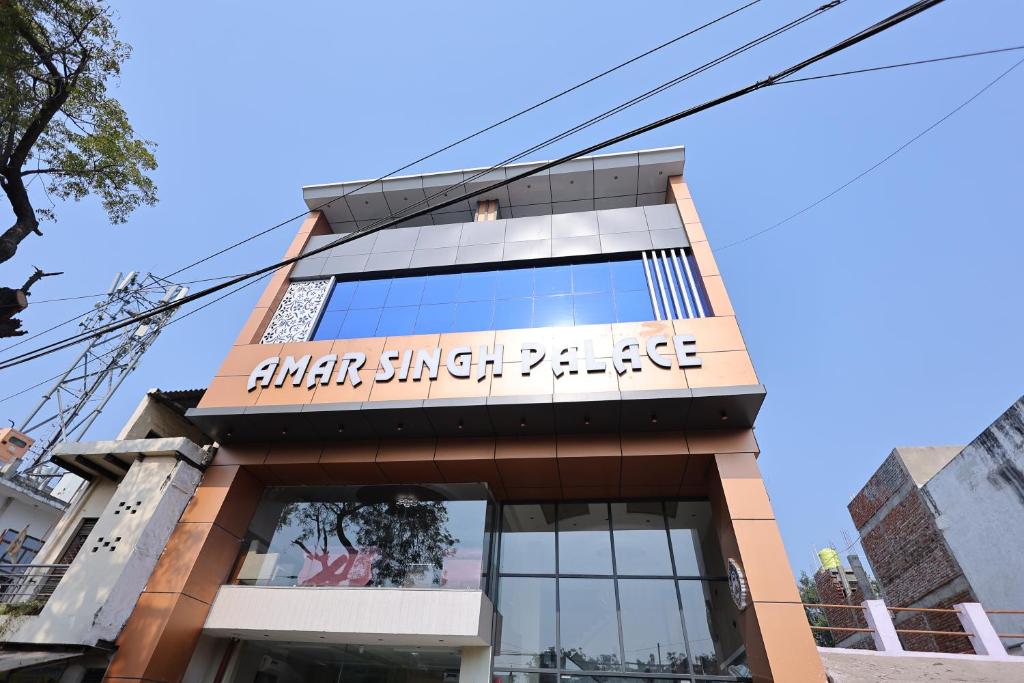 a building with a sign on top of it at Hotel Amar Singh Palace in Agra