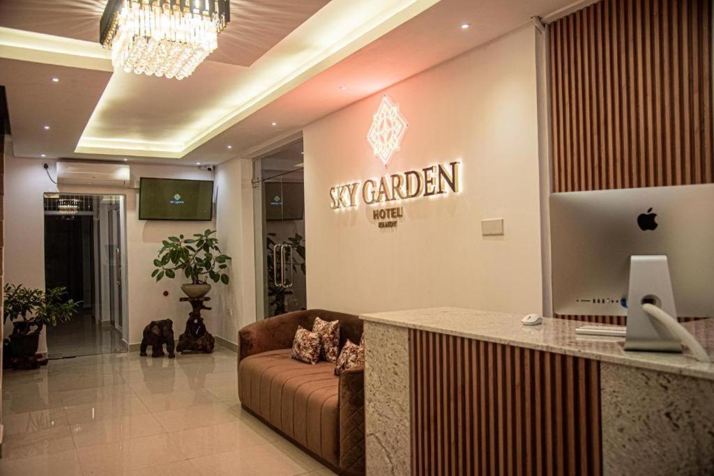 a lobby with a couch and an apple sign on the wall at Sky Garden Kandy in Kandy