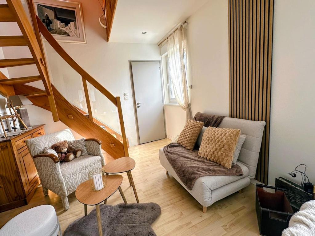 a living room with a couch and a chair at Écrin Ostwald 2 private suites Free parking in Ostwald