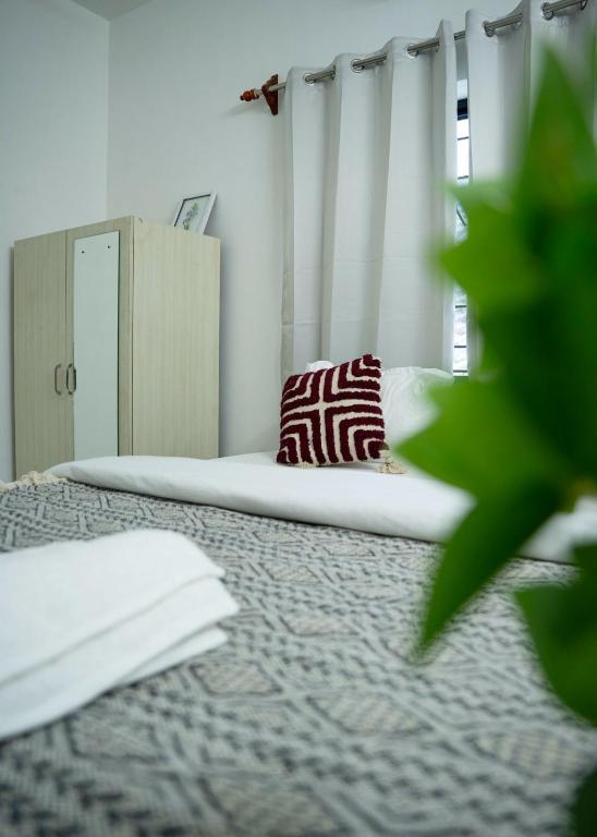 a bedroom with a bed with a pillow on it at Patnem Bliss in Canacona