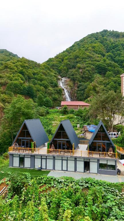 a group of buildings on top of a hill at AĞARaN SUİT BUNGALOV in Rize